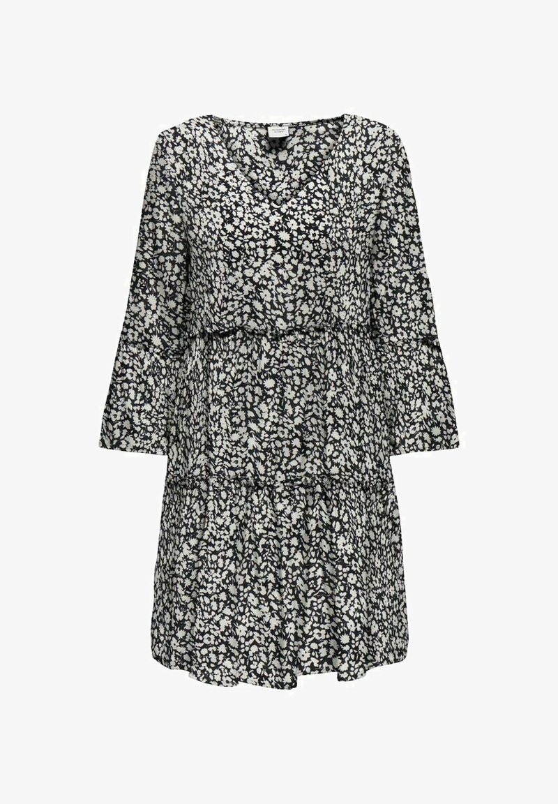 Vestido floral en blanco y negro con mangas largas, escote en V, capas en cascada y una tela ligera y fluida. Presenta pequeños patrones de flores.