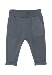 Grå joggarbyxor gjorda av mjukt tyg med elastisk midja, som har två framtida fickor och uppvikta muddar. Slät textur med ett subtilt mönster.
