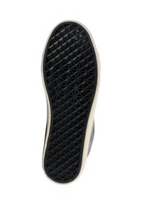 Suela de zapato de goma negra con una textura y un patrón de diamante expresivo. Los bordes son blancos, proporcionando un contraste con la superficie oscura de la suela.