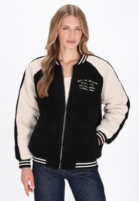 Sort og cremefarvet farveblokkeret bomberjakke lavet af tekstureret fleece, med lynlås foran, ribbede mansetter og broderede detaljer.