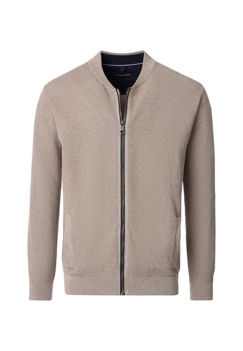 Beige stickad cardigan med dragkedja fram, ribbade ärmslut och fåll. Har sidofickor och ett strukturerat mönster över hela tyget.