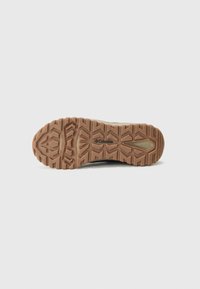 Brown rubber shoe sole with a textured, zigzag pattern; brand name "Columbia" visible near the center.