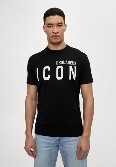 T-shirt nera in cotone con il grande testo bianco "DSQUARED2 ICON" sulla parte anteriore. Collo a giro classico e maniche corte. Vestibilità casual.