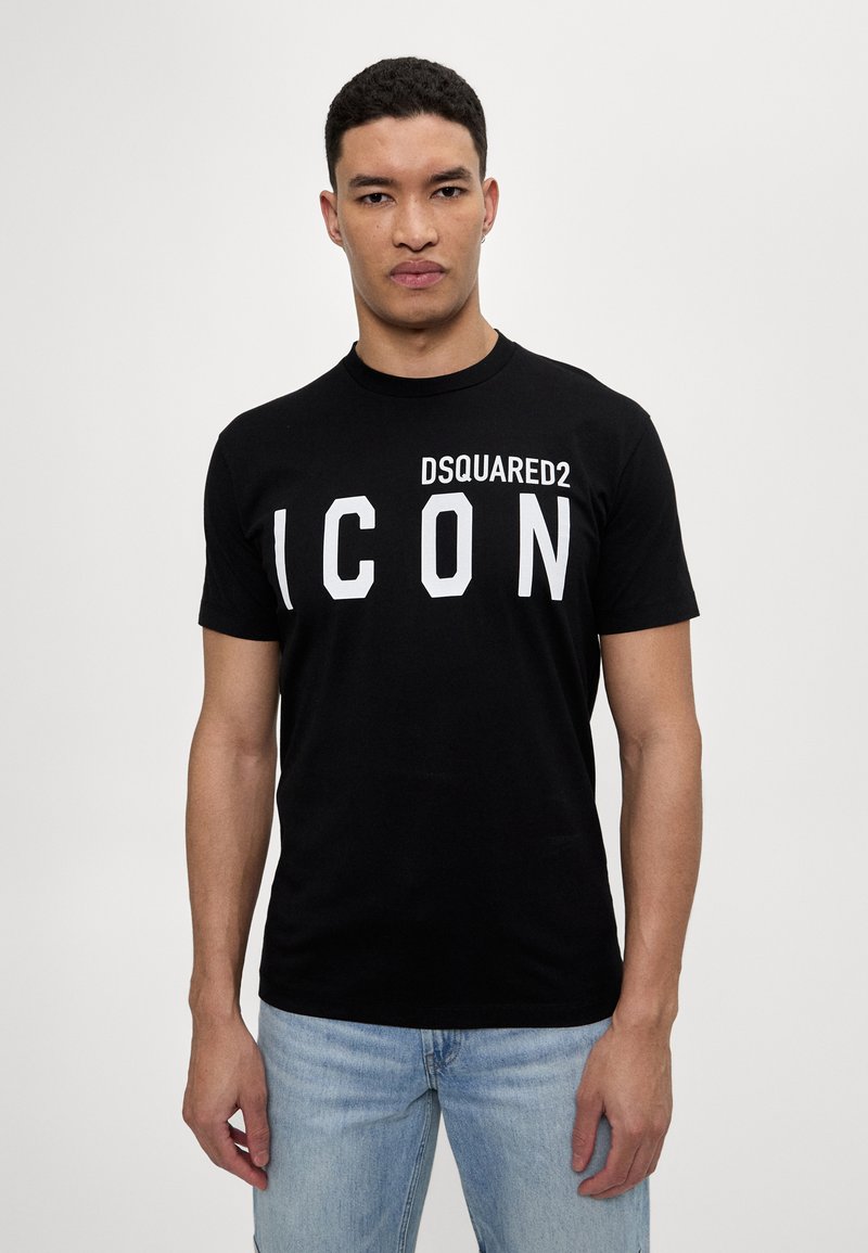 Must Ekstra T-särk mustast puuvillast, millel on ees julge valge "DSQUARED2 ICON" tekst. Klassikaline ümmargune kaelus ja lühikesed varrukad. Lõdva sobivusega.