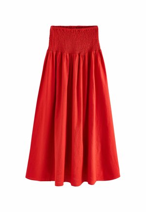Jupe rouge, longueur genou, avec une ceinture smockée, présentant un design fluide et une texture lisse. Fabriquée à partir d'un tissu léger.