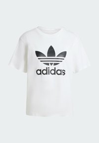 Camiseta de algodón blanca con un gran logotipo negro de Adidas y tres rayas negras debajo del logotipo. Mangas cortas y diseño de corte relajado.