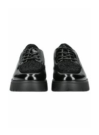 Scarpe oxford nere con finitura lucida in vernice e tessuto nero testurizzato sulla parte superiore. Suola in gomma nera spessa, lacci rotondi.