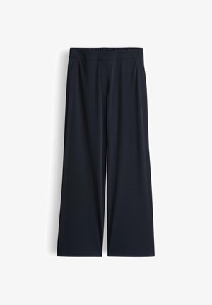 Pantaloni a gamba larga in blu navy scuro, realizzati in tessuto morbido. Presentano una cintura elasticizzata e tasche laterali per funzionalità.