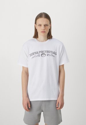 White cotton t-shirt featuring black text that reads "METAPHYSICAL" with decorative leaves above and below, complemented by a round logo.