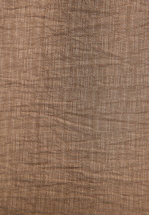 Textured fabric in a warm brown color with a subtle woven pattern and varying thread thickness, providing depth and visual interest.