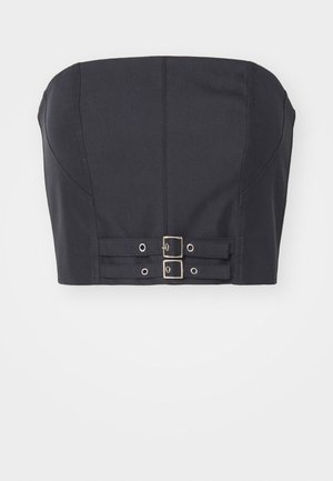 Top court sans manches noir avec un buste structuré, présentant des coutures détaillées et deux boucles en métal à l'avant pour la fermeture.