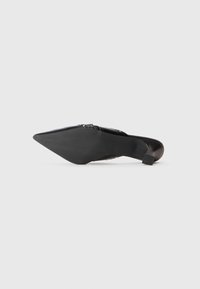 Black pointed-toe high heel shoe shown from the sole, featuring a low, square heel and smooth textured sole.