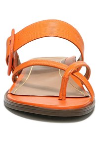 Orange flat sandals with a wide strap and thin cross straps. Smooth texture, flat sole, and a lightly padded footbed with gold accents.