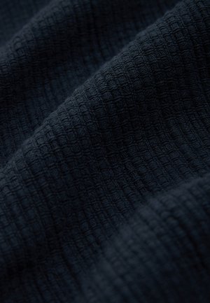 Dark navy textured fabric featuring a grid pattern. The material appears woven, with a soft and slightly raised surface.