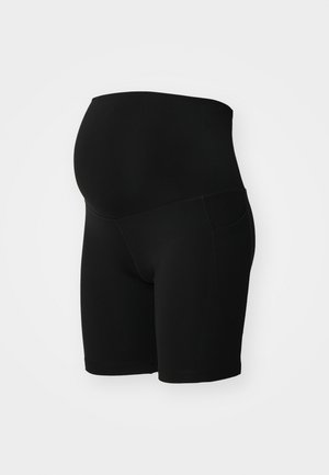 Shorts de maternidad negros, elaborados con tejido elástico. Cintura media con un diseño sin costuras, que incluye bolsillos laterales. Textura suave.