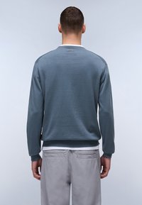 Lichtblauwe sweatshirt met een ronde halslijn, lange mouwen en geribbelde manchetten. De stof lijkt glad met een casual pasvorm.
