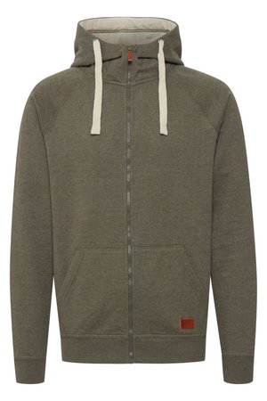 Olivi vihreä vetoketjullinen huppari, joka on valmistettu pehmeästä kankaasta. Hupparissa on vuorattu huppu, beige nyöri, taskut ja pieni brändättävä nahka-patch.