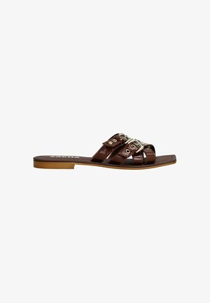 Brown faux leather slide sandals with three crossed straps, featuring gold hardware accents and a flat sole. Smooth texture, minimal design.