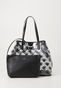 Czarna skórzana torebka z wzorzystym czarno-białym motywem, wyposażona w dwa długie uchwyty oraz odłączaną czarną kieszonkę na zamek.