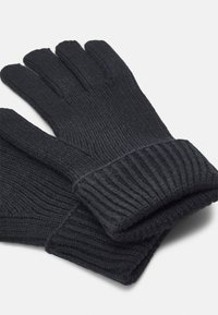 Sorte ribbede handsker med manchet ved håndleddet. Fremstillet af struktureret materiale, med fem fingeråbninger. Enkel og funktionel design.