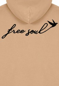 Felpa beige con una texture morbida, caratterizzata da un design ricamato nero che recita "anima libera" insieme a una piccola illustrazione di un uccello.