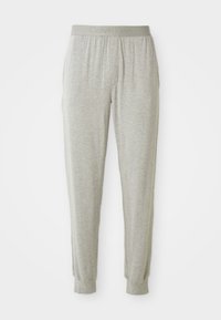 Pantaloni jogger gri deschis, confecționați dintr-un material moale, având un brâu elastic cu inscripția "Calvin Klein" embosată, manșete tăiate și fără buzunare vizibile.