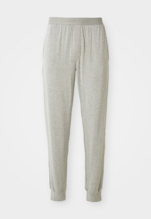 Lichtgrijze joggerbroek gemaakt van zachte stof, met een elastische tailleband met 'Calvin Klein' in reliëf, taps toelopende enkelmanchetten en geen zichtbare zakken.