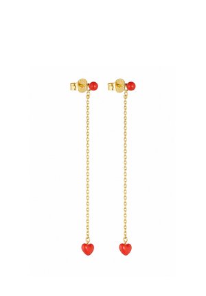 Boucles d’oreilles chaîne en or avec de petits clous ronds rouges en haut et des breloques rouges en forme de cœur suspendues aux extrémités.