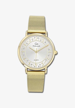 Montre en quartz couleur or avec un cadran argent, dotée d'indices minimalistes et d'accents en cristal. Bracelet en mailles pour un design épuré.