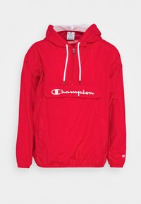 Röd Champion huvtröja med ficka, vit dragsko, framzipper, elastiska muddar och stor framficka med logotext.