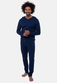 Navy-blaues Loungewear-Set aus weichem Material; Langarmoberteil mit V-Ausschnitt und passenden Jogginghosen mit Kordelzug. Minimalistisches Design, lockere Passform.