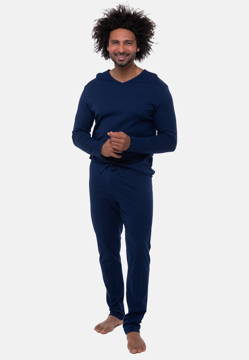 Navy-blaues Loungewear-Set aus weichem Material; Langarmoberteil mit V-Ausschnitt und passenden Jogginghosen mit Kordelzug. Minimalistisches Design, lockere Passform.