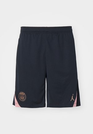 Mørkeblå atletisk shorts lavet af let materiale, med en pink kant på siden og logoer for Paris og Jordan i guld.