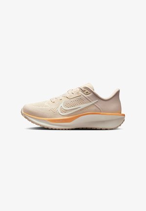 Zapatilla deportiva beige con parte superior de malla texturizada, acento de logo blanco y mediasuela naranja. Cuenta con suela acolchada y sistema de cordones.