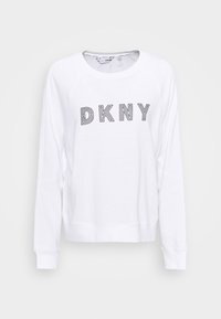 Bílá mikina s dlouhým rukávem, s kulatým výstřihem, raglánovými rukávy a černým nápisem "DKNY" na přední straně. Měkká tkanina s volným střihem.