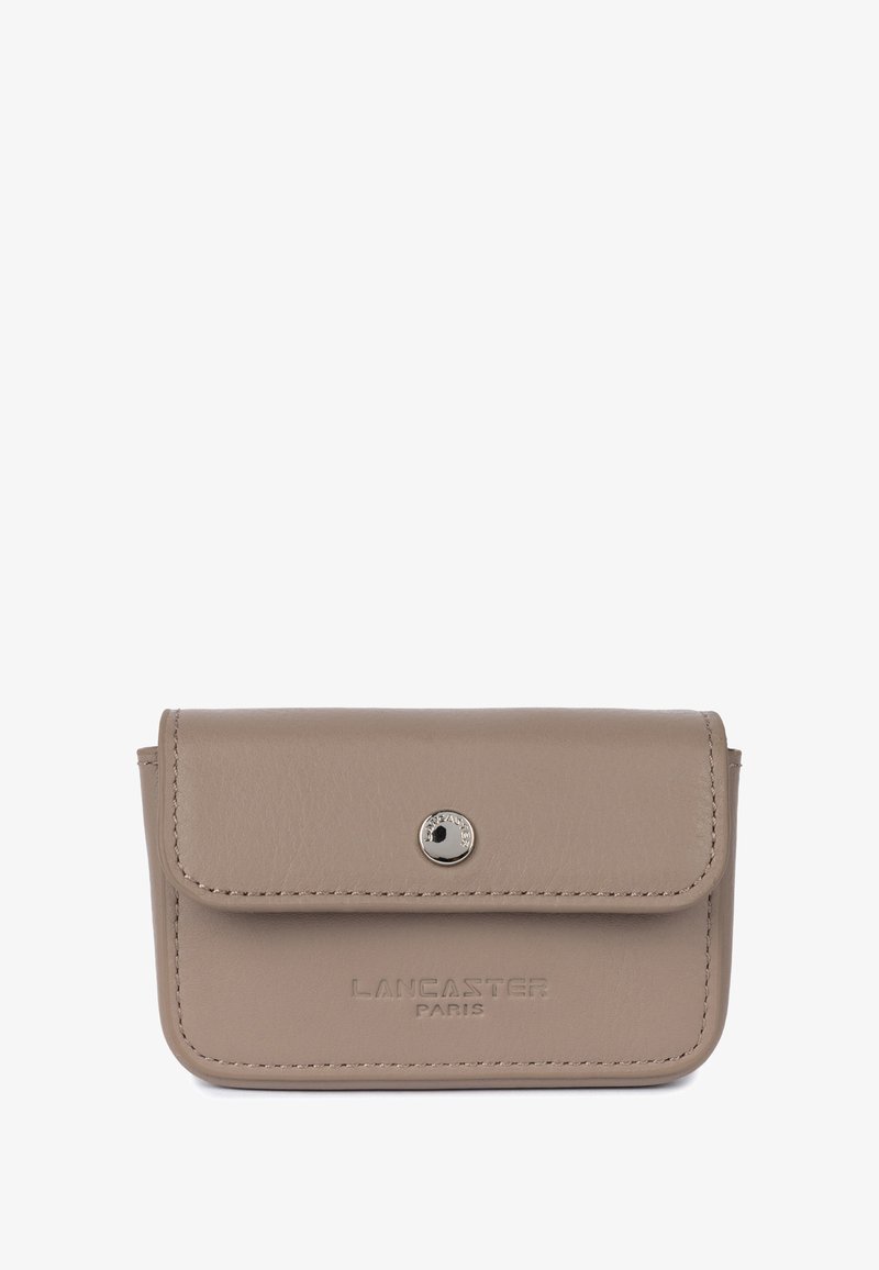 Beige leather cardholder with a flap closure, silver snap button, and embossed "LANCASTER PARIS" branding on the front. Features neat stitching.