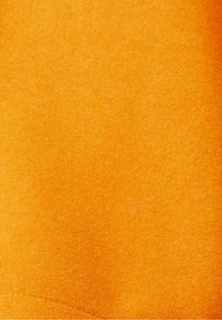 Bright orange felt fabric with a soft texture. Even surface with a subtle sheen and minimal stitching detail along the edge.