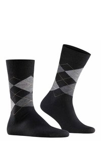 Calcetines argyle en negro y gris con un puño acanalado, que presentan un patrón de rombos y un contraste de costuras doradas sobre una tela suave.