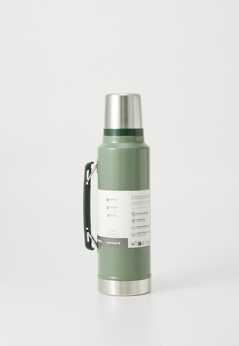 Green stainless steel vacuum flask with a silver lid and green handle, displaying temperature retention details on the label.