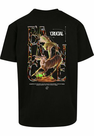 Black t-shirt featuring a graphic print of a leopard and an antelope on a colored background, with stylized text about balance.
