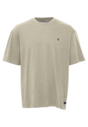Lys beige kortermet T-skjorte laget av myk bomull. Har rund hals og liten marineblå logo på venstre bryst.