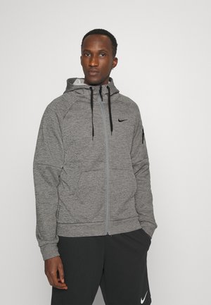 Gray zip-up hoodie with a hood, black accents, and pockets. Made of textured fabric with a Nike logo on the chest and arm.