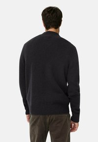 Dunkelgrauer Pullover aus dickem Strickmaterial mit einem gerippten Kragen und Bündchen. Die Rückseite ist schlicht und ohne sichtbare Logos oder Muster.