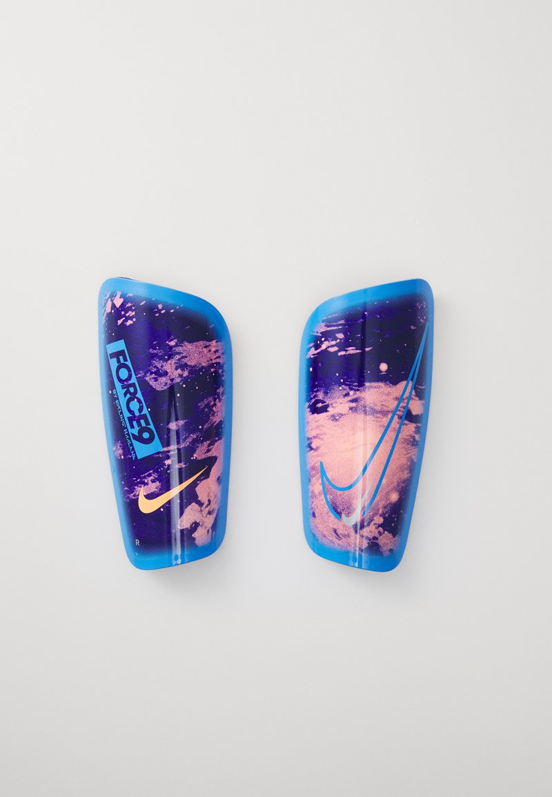 Protège-tibias Nike avec un design brillant bleu et violet, comportant des motifs abstraits, logos et textures. Le protège-tibia droit a une accent rose.