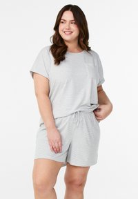 Gray striped loungewear set with a loose short-sleeve top and elastic waist shorts; lightweight fabric with a soft texture and a pocket detail.