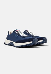Sneakers blu navy con una tomaia in tessuto liscio e dettagli in camoscio. Presentano lacci bianchi, una suola testurizzata e un logo angolato di lato.