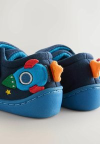Blue fabric shoes with a blue rubber sole, featuring a rocket applique in bright colors and a star design on the heel area.