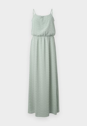 Maxi dress in light green, made of soft fabric with a polka dot pattern, featuring thin straps and an elastic waist for a flowing silhouette.