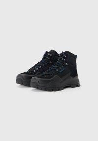 Black hiking boots with mesh panels, blue laces, and metal eyelets. Rugged rubber sole and padded collar for support. Durable material.