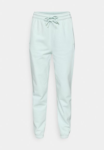 Ανοιχτό μέντα πράσινο αθλητικό παντελόνι με ελαστική μέση, κορδόνι στη μέση, πλαϊνές τσέπες και σχιστό κάτω μέρος. Κατασκευασμένο από απαλό, λείο ύφασμα.